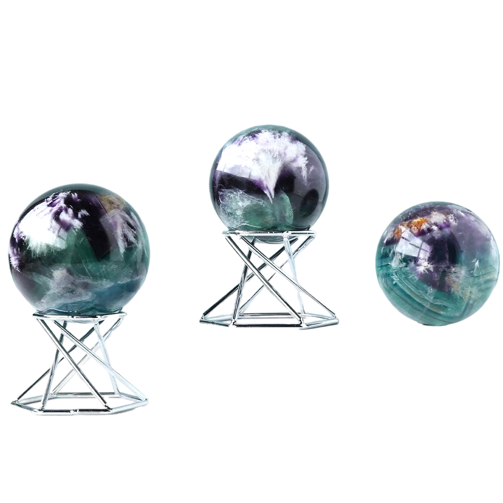 Set of three galaxy crystal balls on geometric metal stands for desk or shelf decor