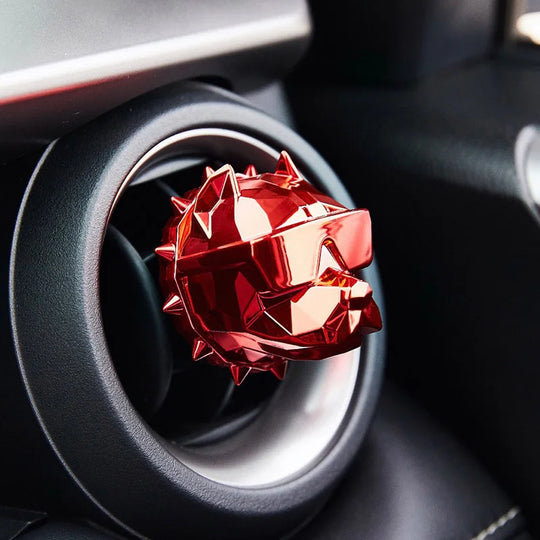 Red bulldog car vent diffuser clipped to round air vent.