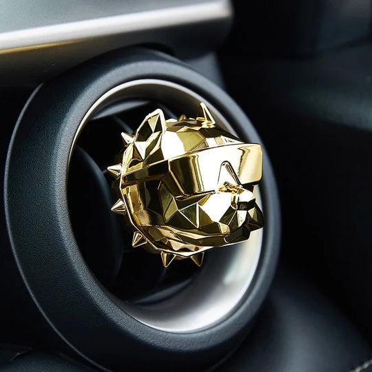 Gold bulldog car vent diffuser clipped to car air vent.