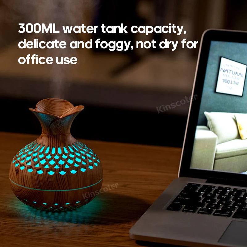 USB-powered flower humidifier placed beside laptop on desk emitting mist.