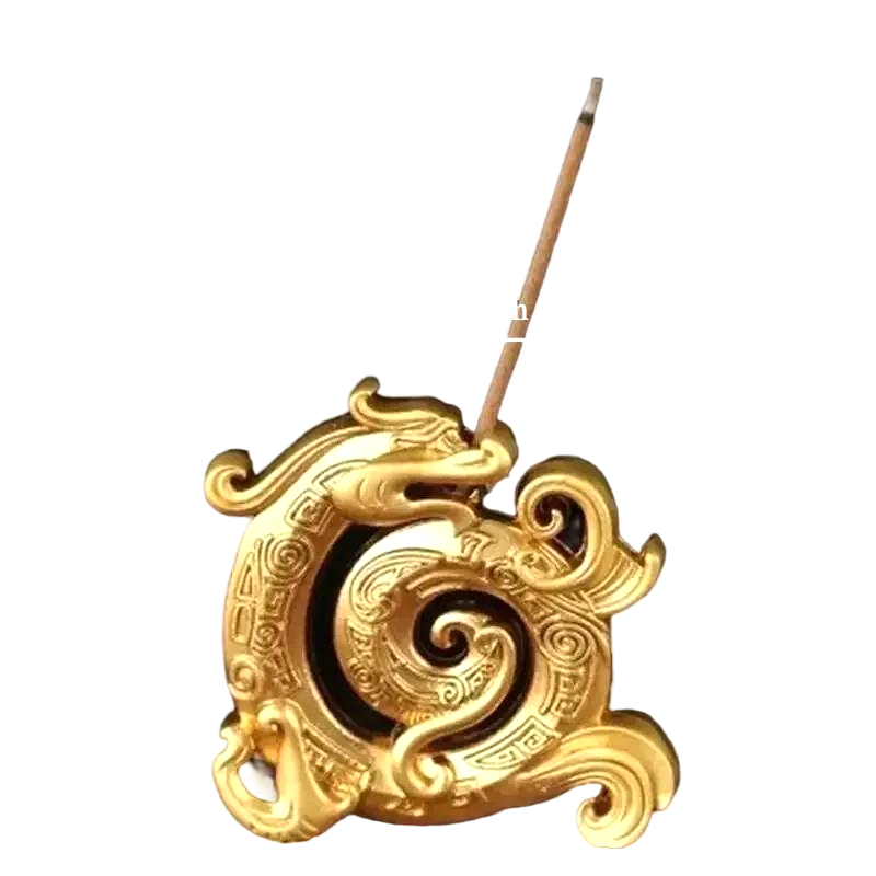 Golden dragon incense holder with spiral design, incense stick placed upright, compact decorative burner.