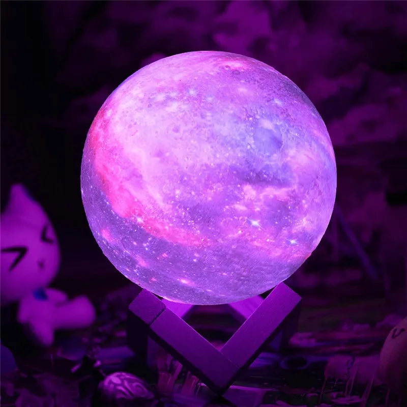 Purple glowing moon lamp on wooden stand used as night light.