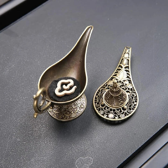 Decorative Aladdin lamp incense burner open, showing incense placement inside metal design.