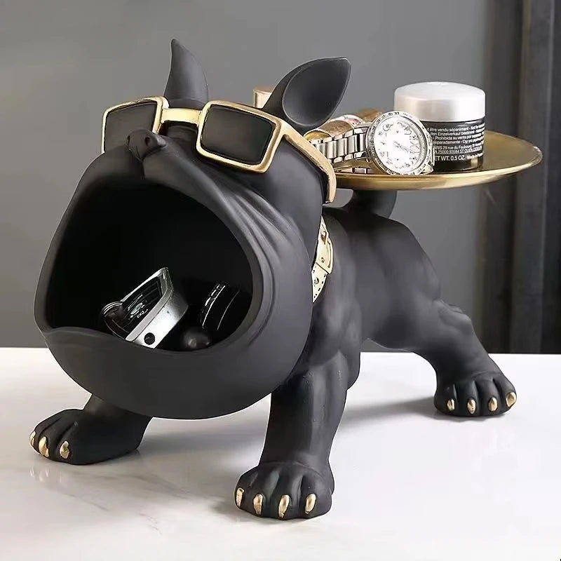 Black bulldog valet tray with gold sunglasses and collar, holding jewelry on gold tray platform