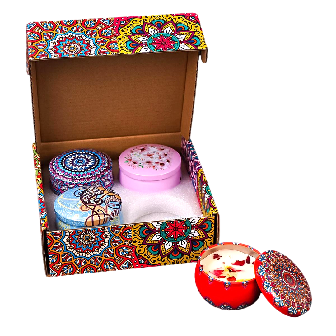 Aromatherapy candle gift set with four colorful tins in decorative mandala box, one candle open with rose petals